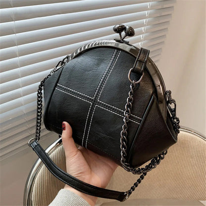 Women's Black Kiss-Lock Cross-Stitch Shoulder Bag - primary photo, shown with a person (1 of 2)