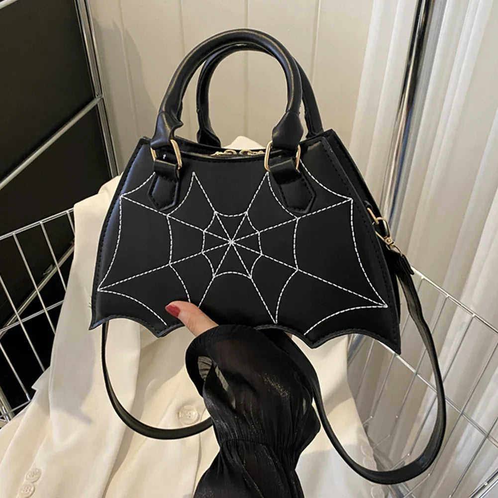 Women's Black Spiderweb Bat-Wing Handbag - primary photo, shown with a person (1 of 2)