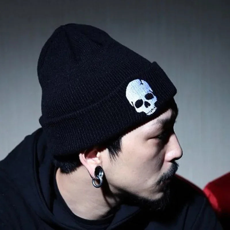 Men's Black Red White Embroidered Skull Beanie - alternate view, shown with a person (2 of 3)