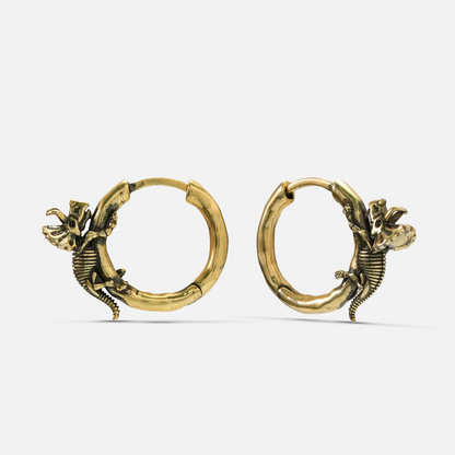 Pair of gold Adaptive Evolution hoop earrings with small skeletal creature details