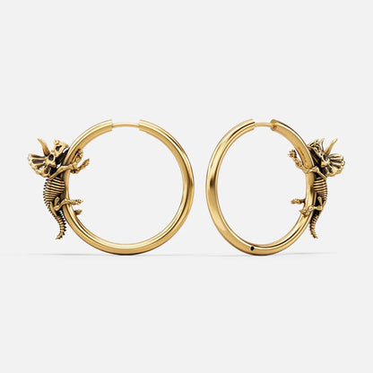 Pair of gold Adaptive Evolution hoop earrings with small creature details