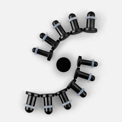 Black Aurora ear stretching plugs arranged in a curved size progression on a white background