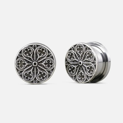 Pair of silver-tone ear plugs with a round cathedral rose window design, front and side view