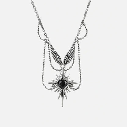 Silver-tone layered necklace with a winged eye starburst pendant and dangling spike