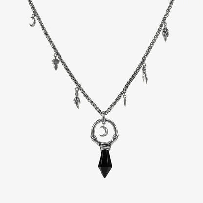 Silver Crescent Ward Necklace with black obsidian spike pendant, crescent moon charm, bone ring detail, and leaf-and-tooth chain accents on a clean background.