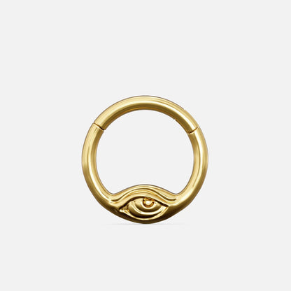 Gold-tone Eyelock Clicker with a rounded ring and a sculpted eye detail along the lower edge.