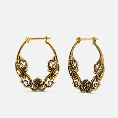 Pair of antique gold-tone hoop earrings featuring an ornate floral scroll pattern, front view