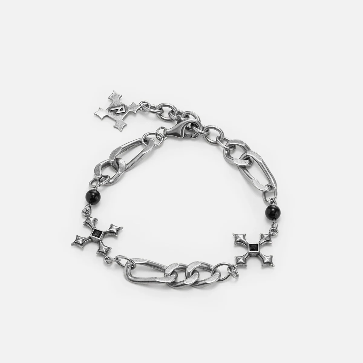 Fractured Creed Bracelet in antiqued silver with fractured cross-inspired metalwork and black obsidian, shown on white.
