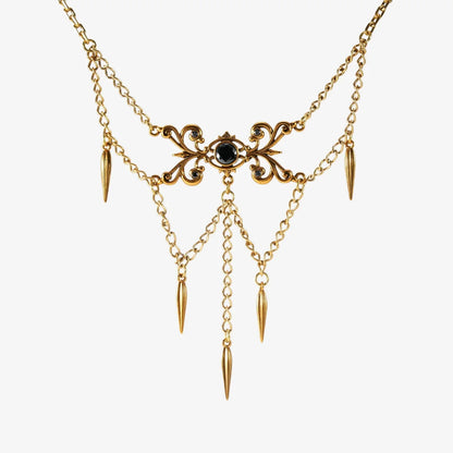 Gold-tone Gothic Cascade layered necklace with a black center stone and multiple spike drops