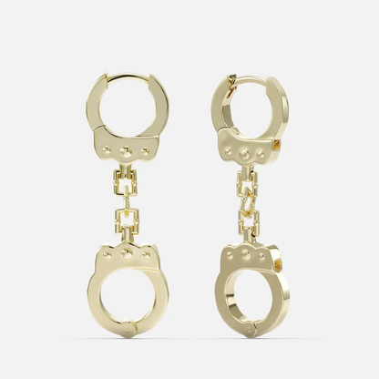 Gold-tone huggie earrings with a chain link connecting to a handcuff-shaped charm, front view
