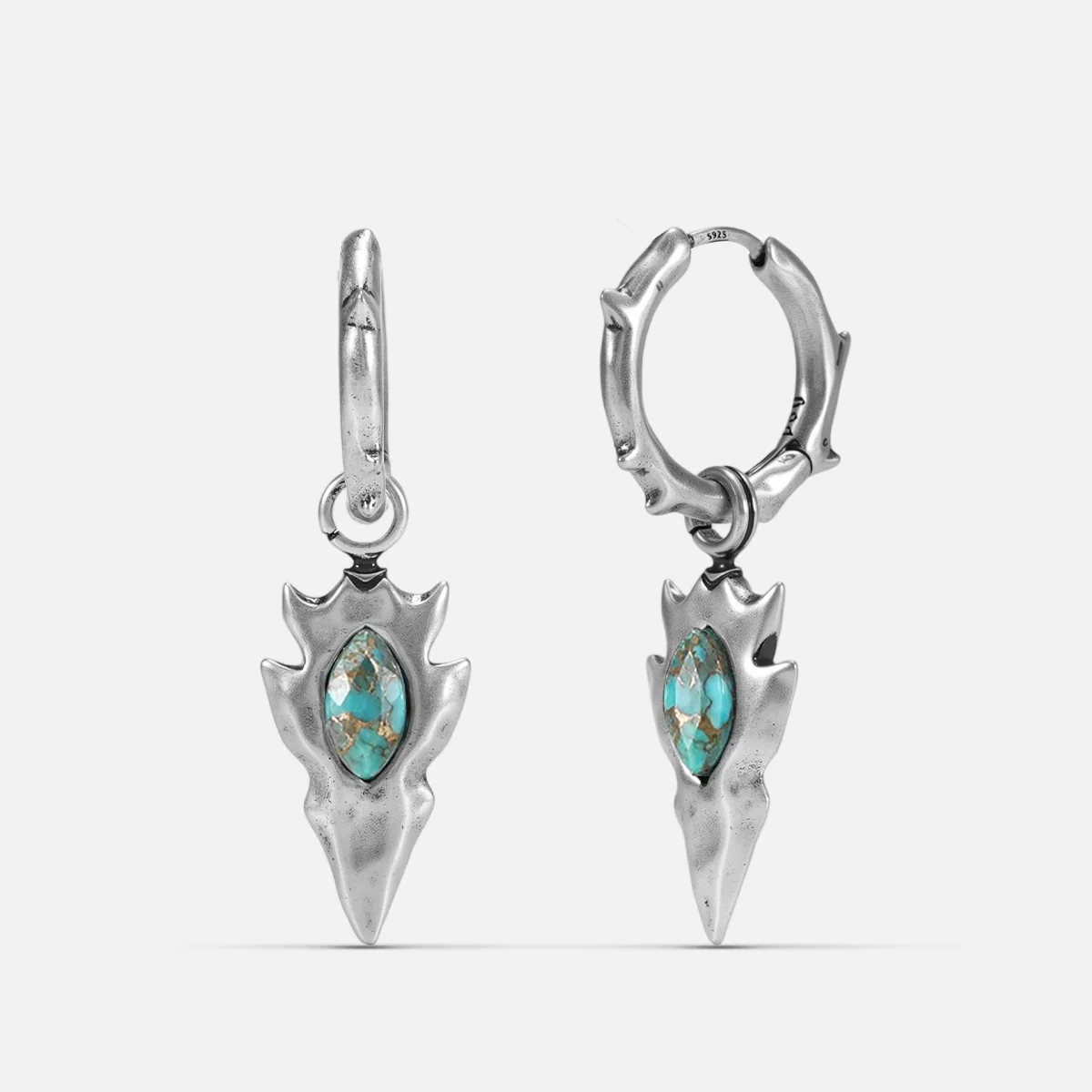Silver-tone Knapped Stone Earrings feature turquoise marquise stones and arrowhead drop pendants.