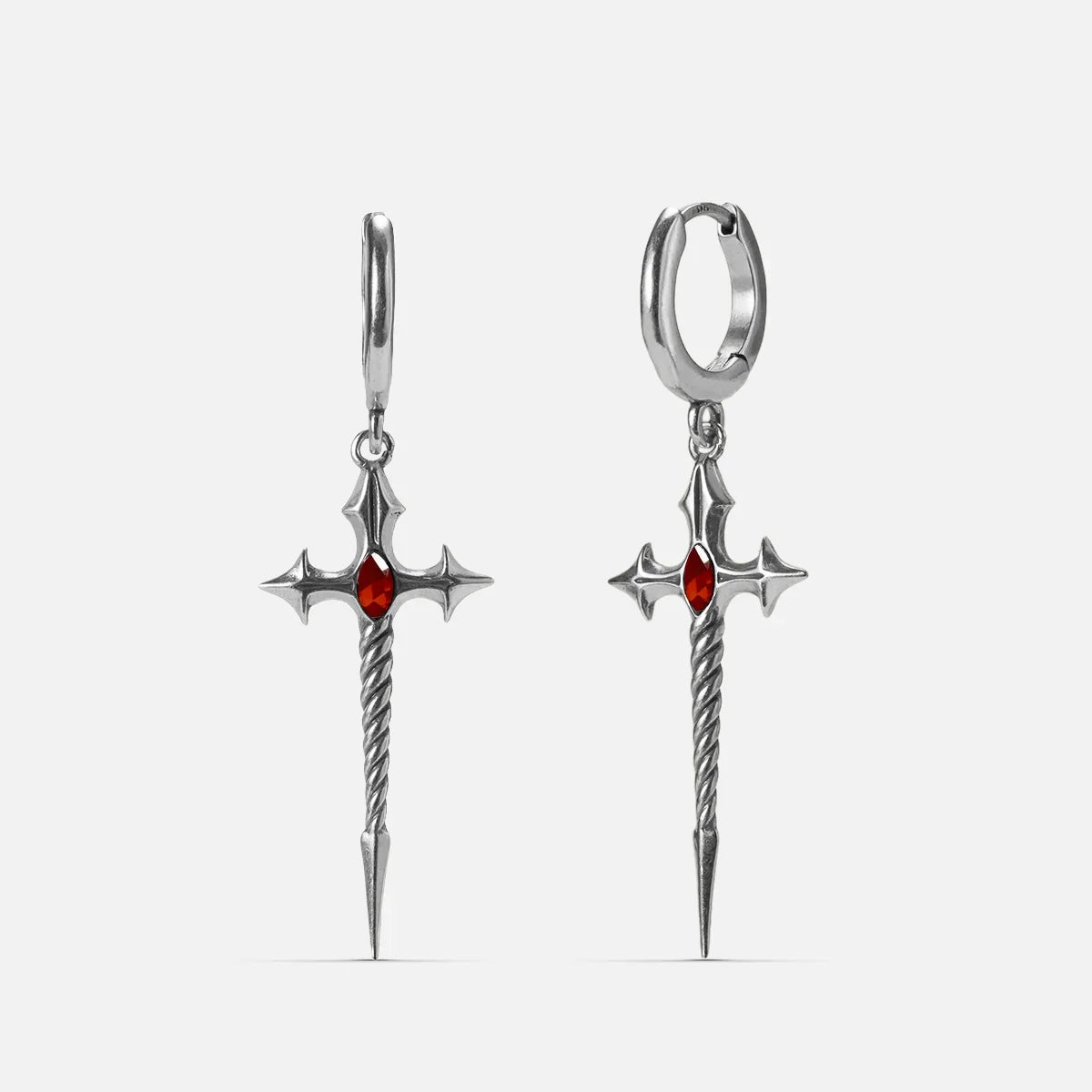 Silver-tone Longinus Godpiercer earrings with red stones, twisted shafts, and spear points
