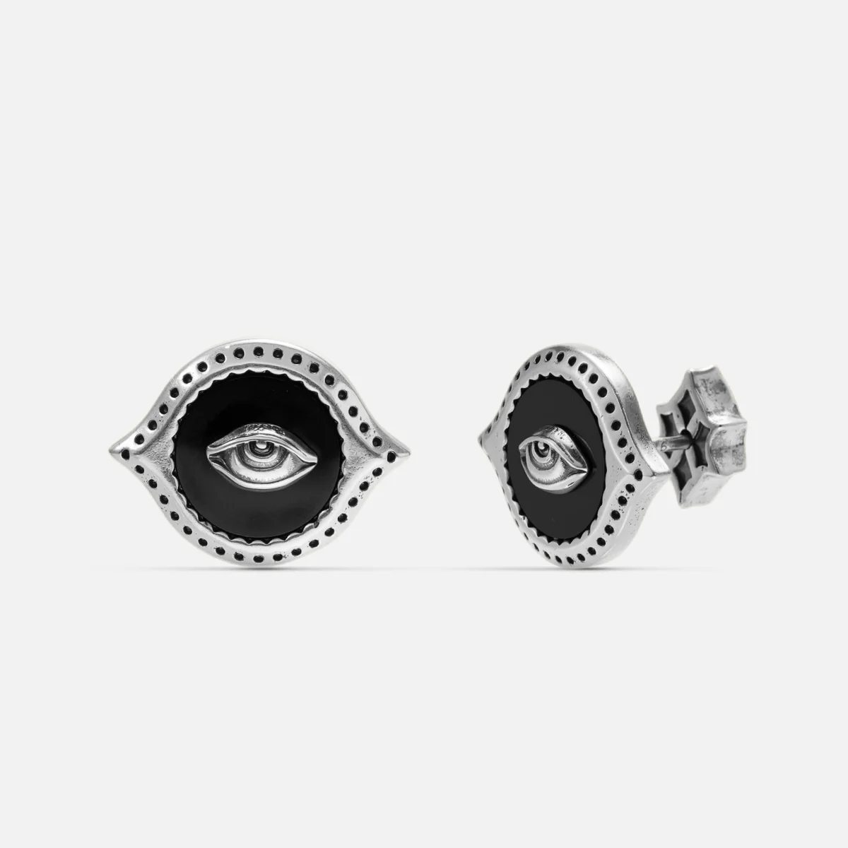 Antiqued silver-tone Mirror Witness Stud Earrings shown from front and side views with raised eye motifs and round black obsidian inlays.