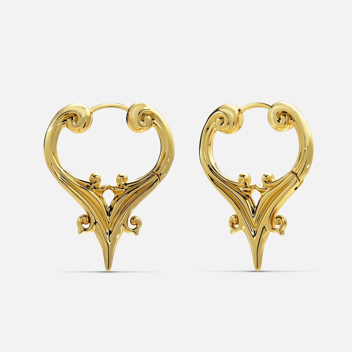 Gold-tone hoop earrings with a scrolled crest design and a pointed drop, shown as a pair against a plain backdrop