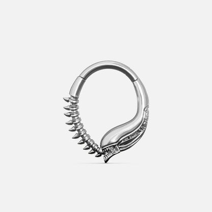 Silver-tone Ouroboros Clicker with a serpent-inspired curved form and raised spine details along the lower edge.
