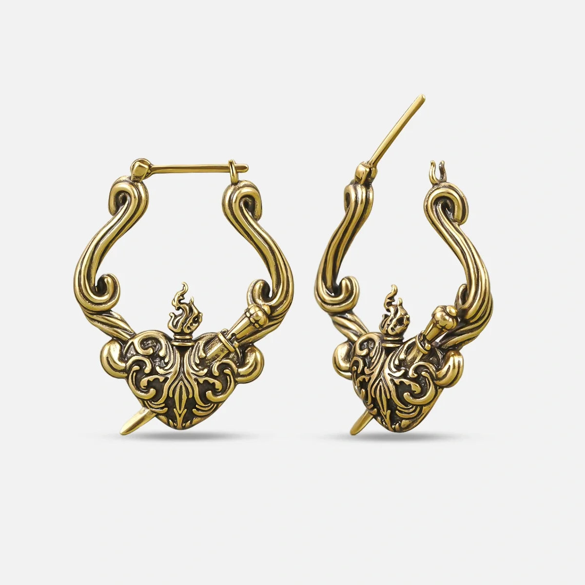 Pair of antique gold-tone hoop earrings with a flaming heart and dagger motif, shown front and side view