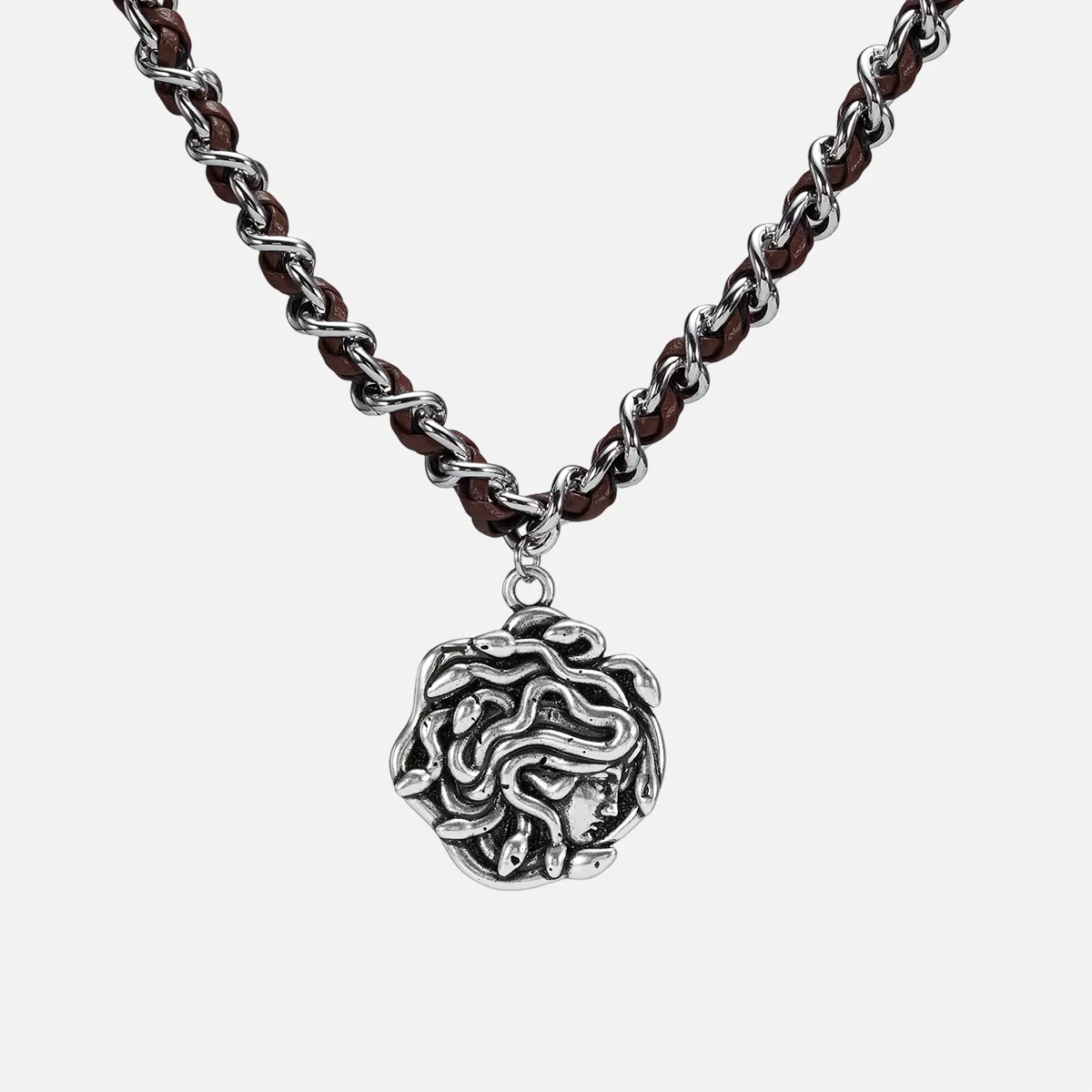 petrified power necklace in silver shown in a front close-up view, featuring a medusa-inspired pendant on a braided chain