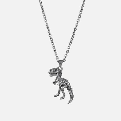 Silver-tone chain necklace with a dinosaur skeleton pendant shaped like a T-rex, laid flat