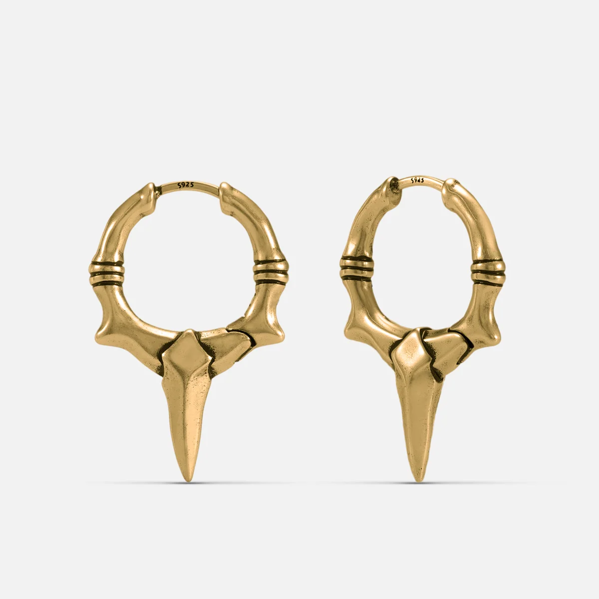 Gold-tone Primal Blade Earrings feature a dagger blade hoop silhouette and an antiqued finish.