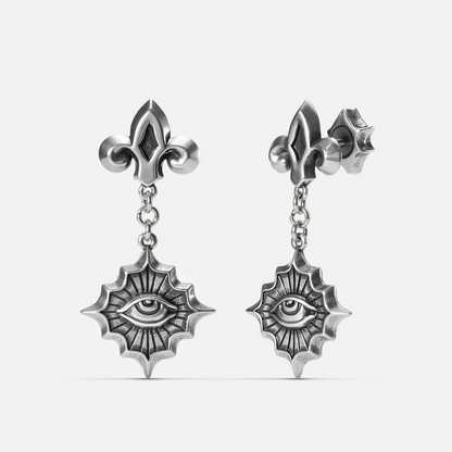 Antiqued silver-tone Radiant Witness Drop Earrings shown from front and side views with sculpted eye motifs, radiating pointed frames, and fleur-de-lis studs.
