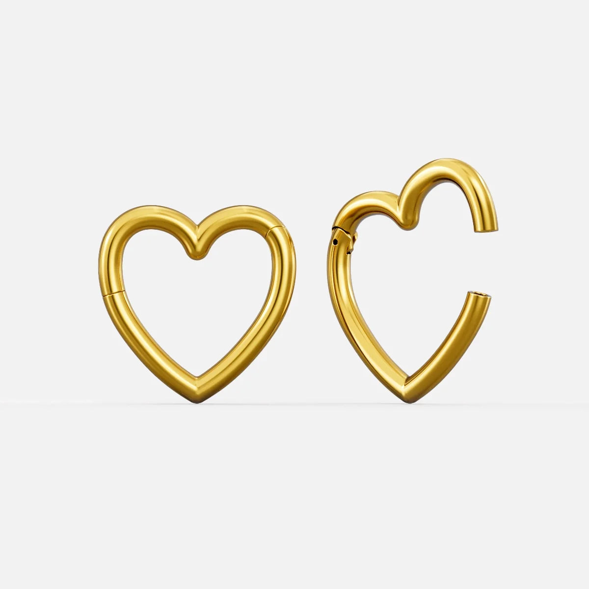 Gold-tone heart-shaped hinged ear weights, one closed and one open showing the clasp