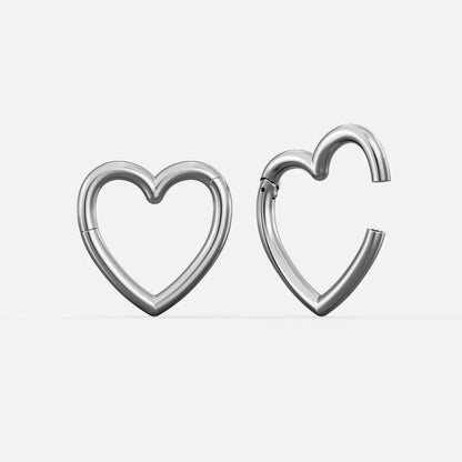 Silver-tone heart-shaped hinged ear weights, one closed and one open showing the clasp