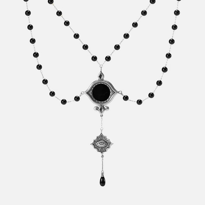 Antiqued silver-tone Scrying Mirror Necklace with doubled black bead chains, an oval black obsidian centerpiece, an eye charm, and a teardrop accent.