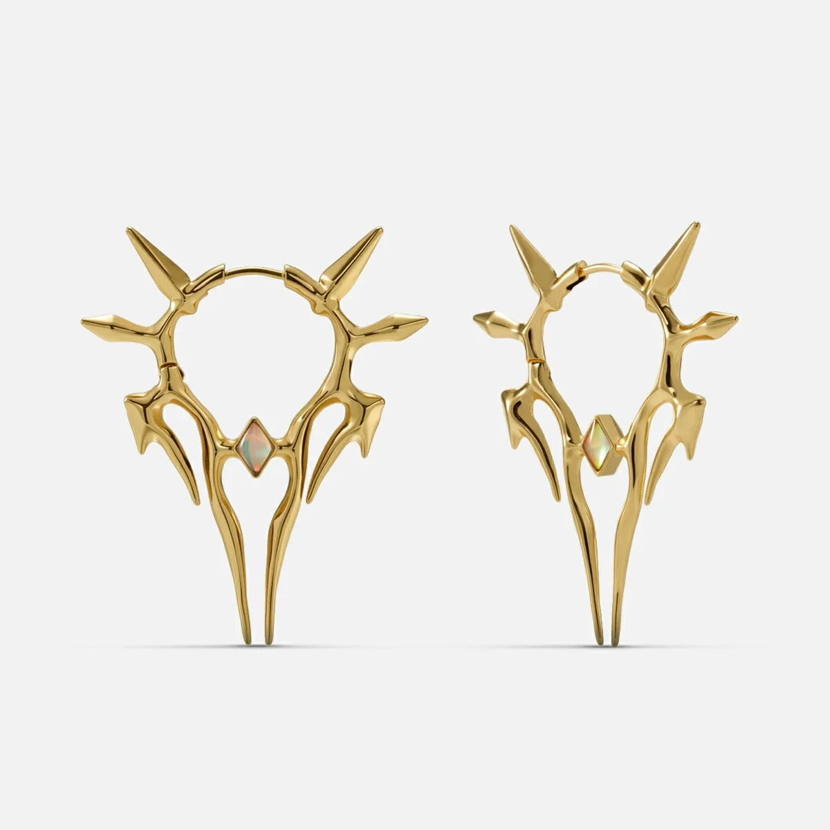 Pair of gold-tone spiked hoop earrings with a small opal-like stone, shown front and side view on a plain background