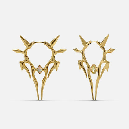 Pair of gold-tone spiked hoop earrings with a small opal-like stone, shown front and side view on a plain background