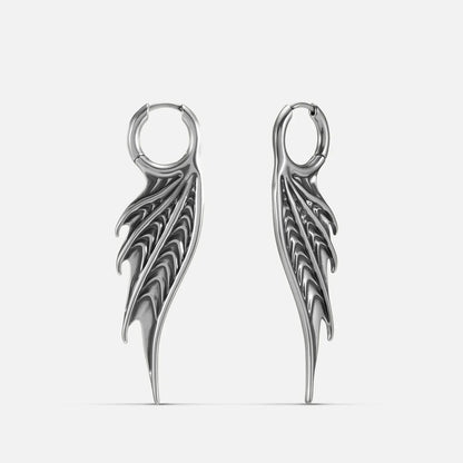 Silver Spined Wing Earrings with long ribbed wing drops, sharp fin-like ridges, and hoop design on a clean background.