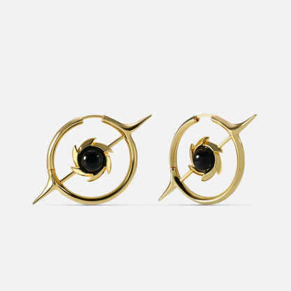 Gold-tone hoop earrings with a star design and round black stone center, front view pair