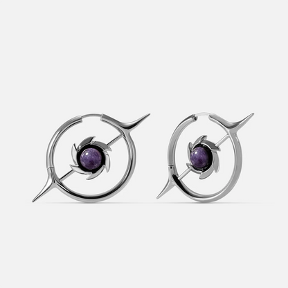 Silver-tone hoop earrings with a star-shaped pendant and round purple stone center, front view pair