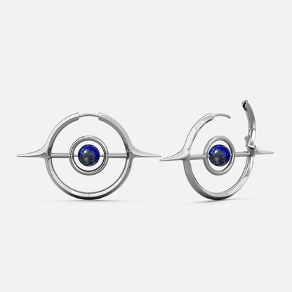 Silver-tone Stellar Grace hoop earrings with spike accents and a blue stone center, shown front and side view