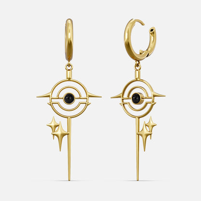 Gold-tone drop earrings with a star burst circle design and black stone center, front view pair