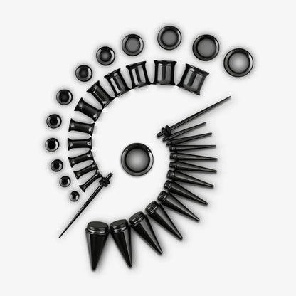 Black ear stretching kit with tapers, tunnels and plugs arranged in a spiral pattern