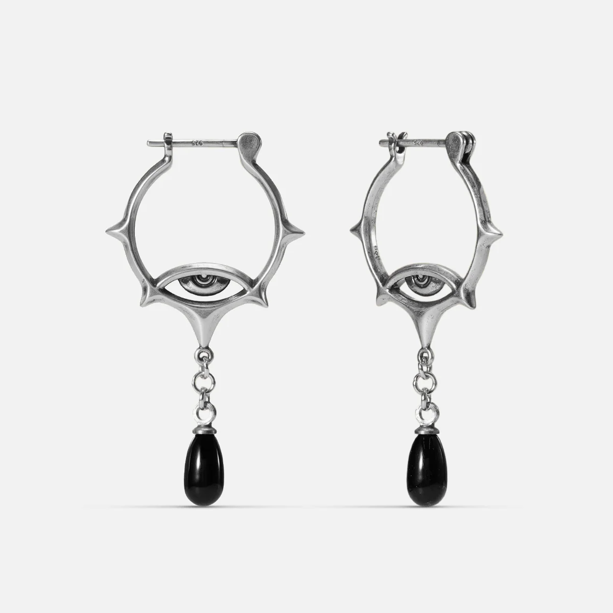 Antiqued silver-tone Thorned Gaze Hoop Earrings with open thorned frames, engraved eye motifs, and suspended black teardrop accents.