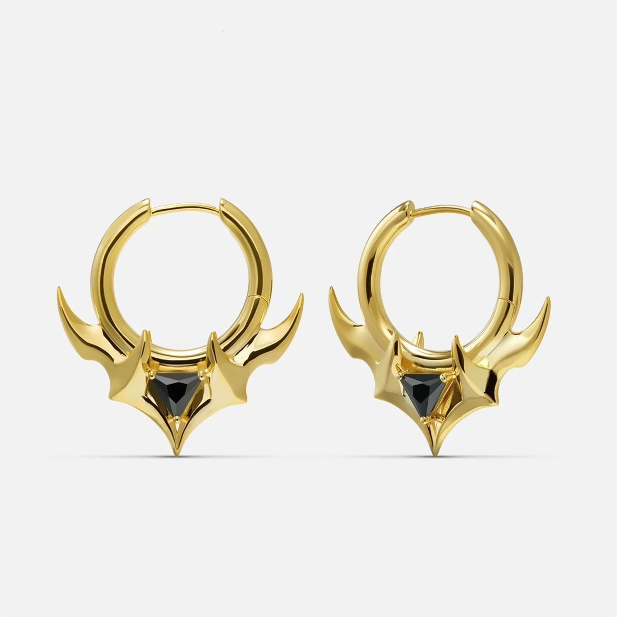Pair of gold Trident Crest stone hoop earrings with black center accents