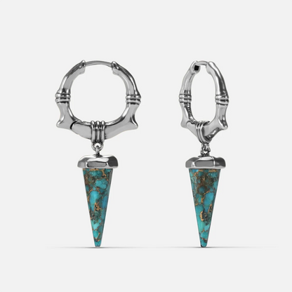 Silver-tone Unearthed Spike Earrings feature turquoise spike drops and bone-textured hoops.