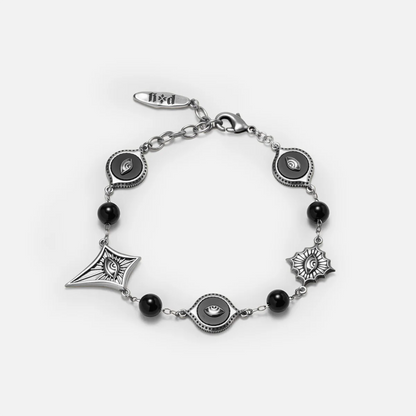 Antiqued silver-tone Unseen Orbit Bracelet with black obsidian beads, eye-shaped links, and sculpted eye medallions in pointed frames.