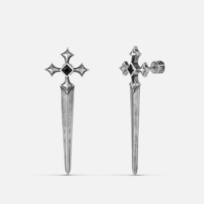 Vesper Blade Stud Earrings in antiqued silver with blade-shaped cross design and black obsidian, shown as a pair on white.