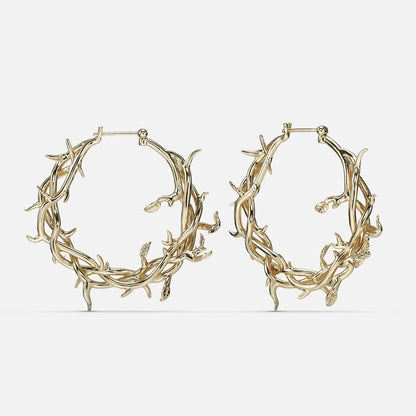 Gold-tone Vine Whispers hoop earrings shaped from twisting thorny branches