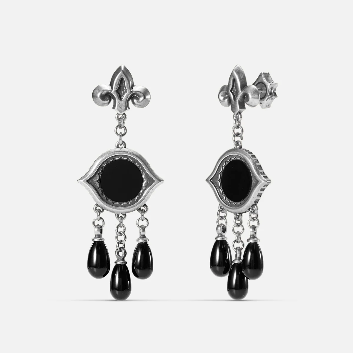Antiqued silver-tone Votive Mirror Earrings shown from front and side views with round black obsidian centers, eye-shaped frames, and three suspended black drops.