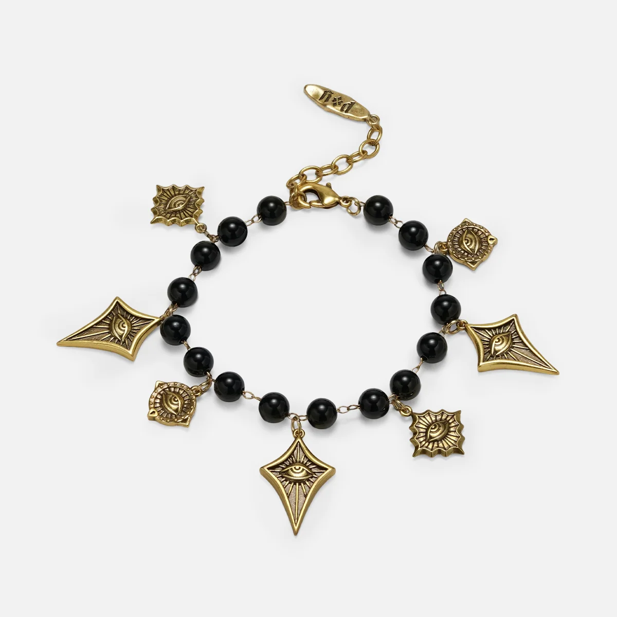 A gold and black beaded charm bracelet featuring geometric and floral charms, displayed on a light gray background.