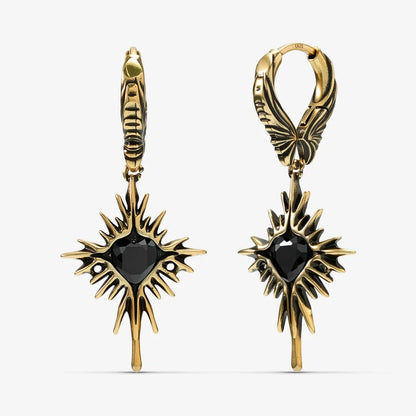Pair of gold-tone Winged Heartburst hoop earrings shown from front and side with black heart centers
