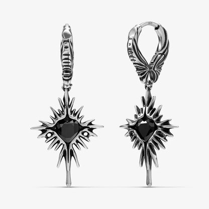 Silver-tone Winged Heartburst earrings with black heart centers, spiked rays, and pointed drops